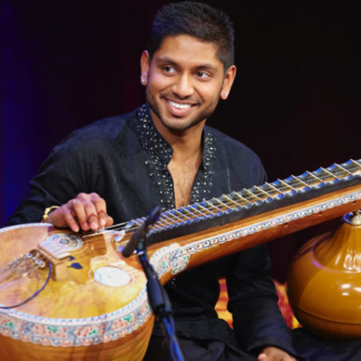 Hari Sivanesan is one of the UK’s most acclaimed Veena Artists. Born in the UK, but trained in both the UK and India, he is now a unique artist and recent Melbournian. He has featured at various festivals such as Darbar UK, WOMAD UK. At a young age he worked with exBeatle George Harrison and sitar Maestro Ravi Shankar on their Chants of India Album, touring through the USA with the Festival of India Project and featuring as the veena artist in various projects at Dartingon Festival. Hari was chosen by BBC Radio 3 as their Would Routes Mentee to produce a series of radio programs presenting Carnatic music to UK radio listeners. He presented the first South Asian Classical BBC Prom in 2011 (the first time Carnatic music featured at the Proms).He recently released an EP with Multicultural Arts Victoria and has now started teaching and sharing his unique style of singing and playing.